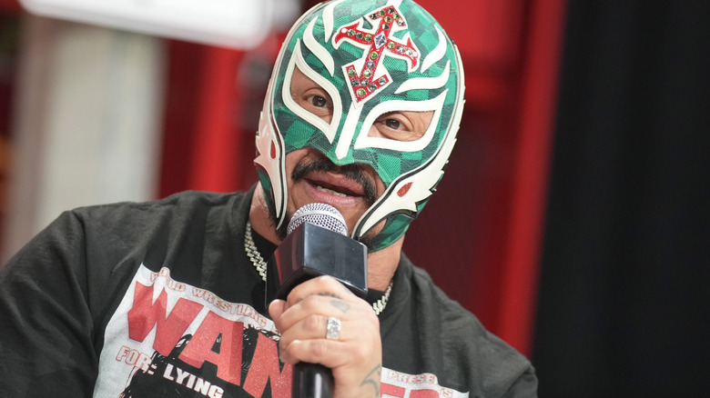 Rey Mysterio holding a microphone