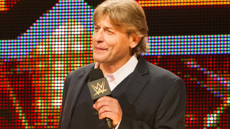 William Regal holding a microphone