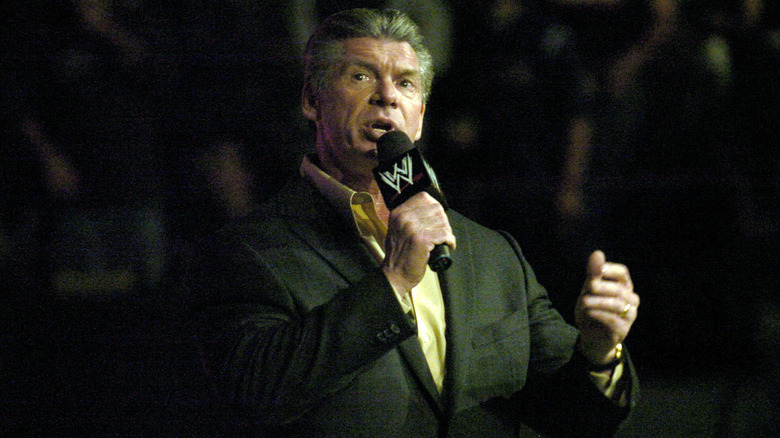 Vince McMahon addressing the crowd during a WWE show.