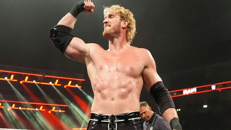 Logan Paul flexes in the middle of the ring during a match against Rey Mysterio on 