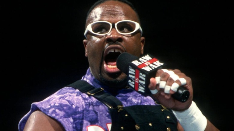 D-Von Dudley cuts a promo into the microphone in the middle of the ring on an episode of 