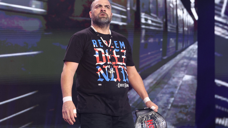 Eddie Kingston carrying title belt