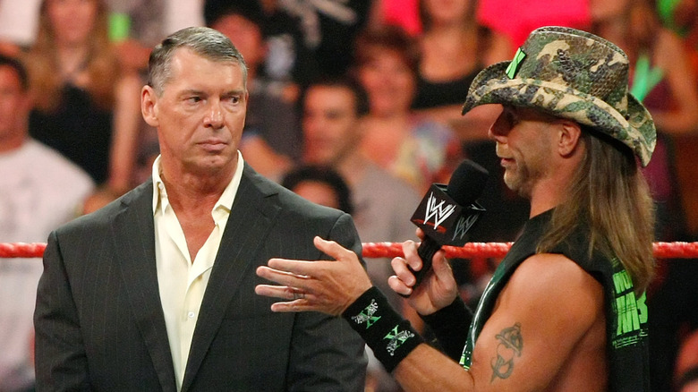 Vince McMahon and Shawn Michaels during a promo segment on screen.