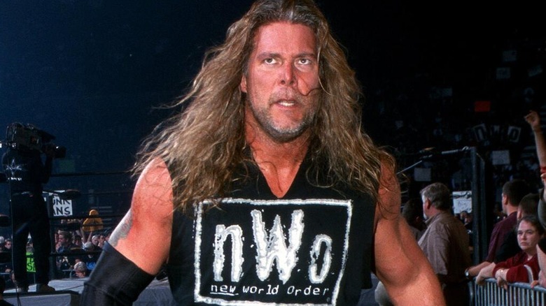 Kevin Nash on his way to the stage after an in-ring segment in WCW, while wearing a black and white nWo t-shirt.