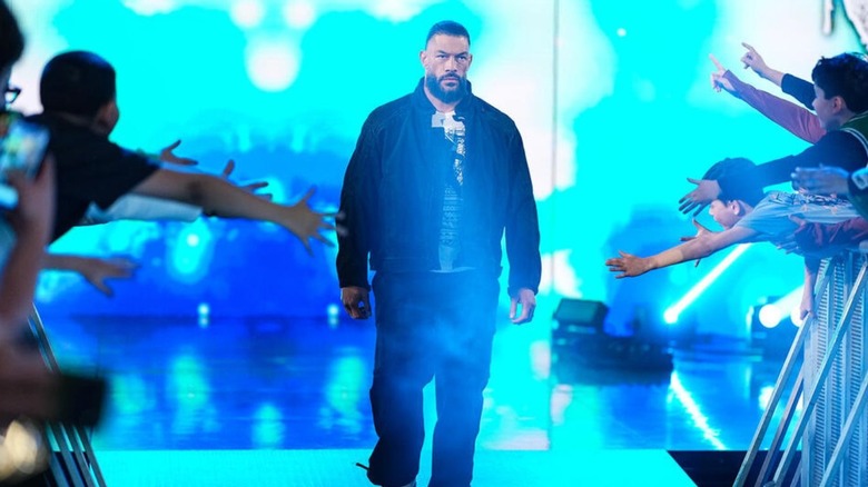 Roman Reigns makes his way down the ramp to the ring for a promo segment involving the Usos and CM Punk during an episode of 