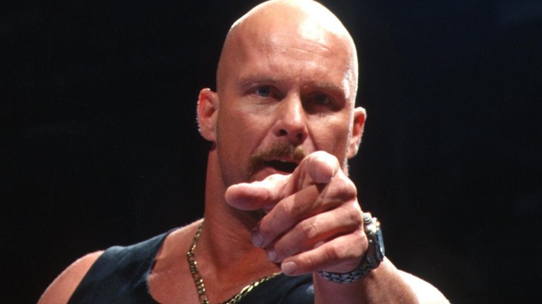 Stone Cold Steve Austin pointing towards the camera while in ring during an episode of 