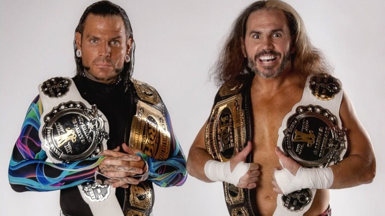 Jeff and Matt Hardy posing with their tag team championships.