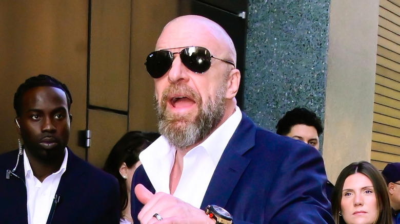 Triple H speaking loudly while wearing shades