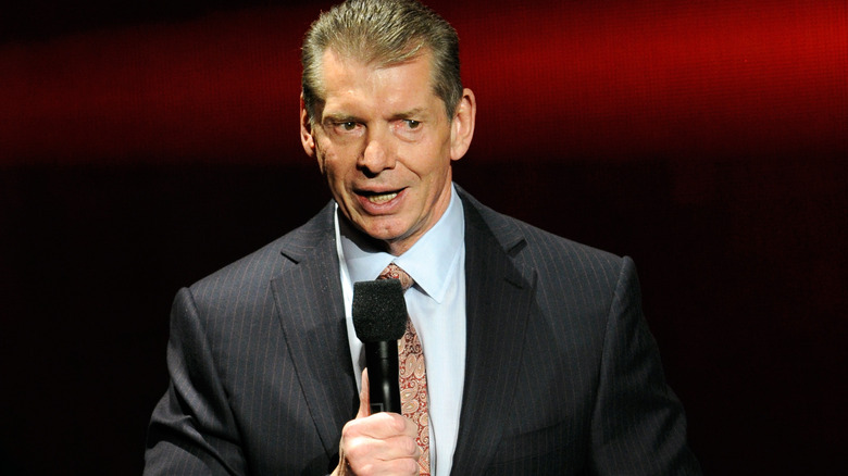 Vince McMahon address the crowd onstage.
