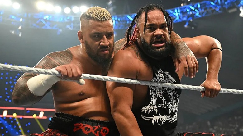 Solo Sikoa puts his arm around his cousin Jacob Fatu after Fatu helps The New Bloodline clean house