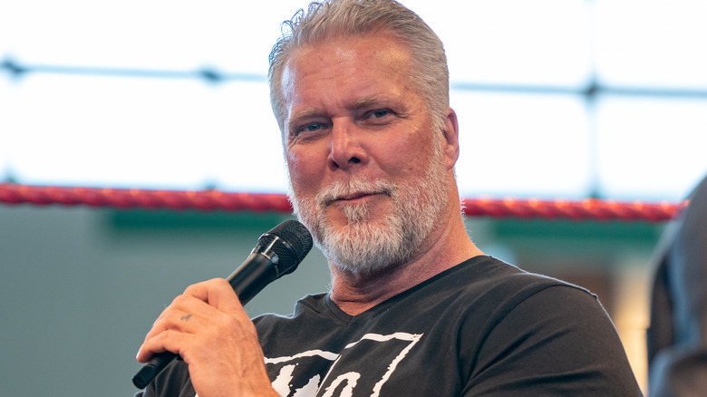 Kevin Nash holding a microphone