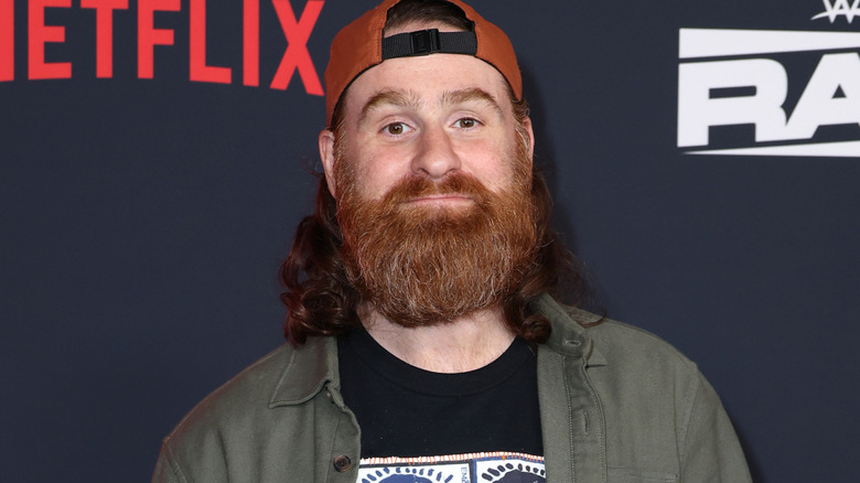 Sami Zayn wearing a backwards hat