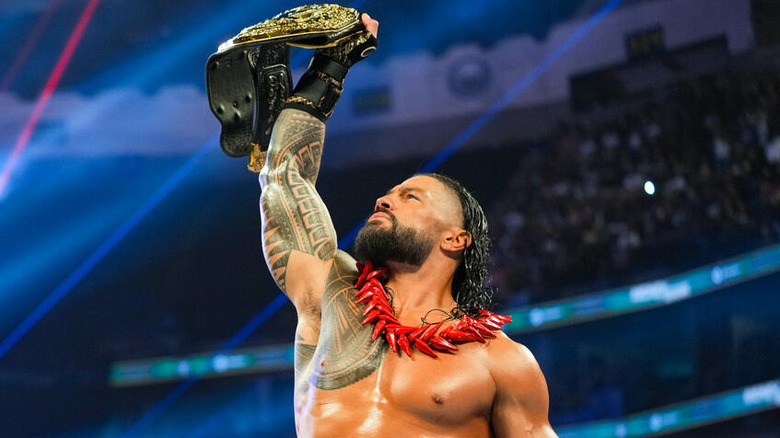 Roman Reigns holds up the World Heavyweight Title