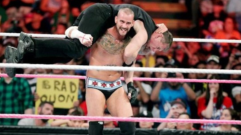CM Punk with Vince McMahon on his shoulders for the GTS
