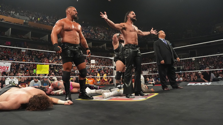 Seth Rollins, Bron Breakker, Paul Heyman, and Bronson Reed stand over a fallen CM Punk, Sami Zayn, and Jey Uso on "WWE Raw"