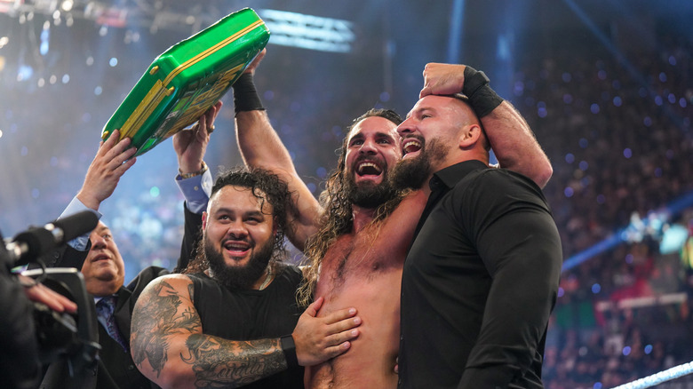 Seth Rollins celebrates with The Vision