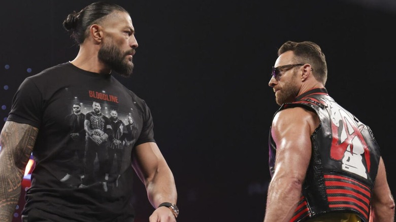 Roman Reigns and LA Knight staring at each other