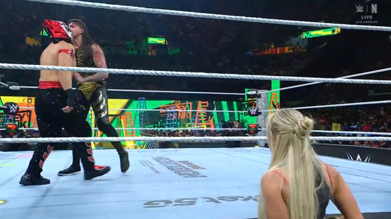 Dominik and Octagón in the ring as Morgan watches from the outside