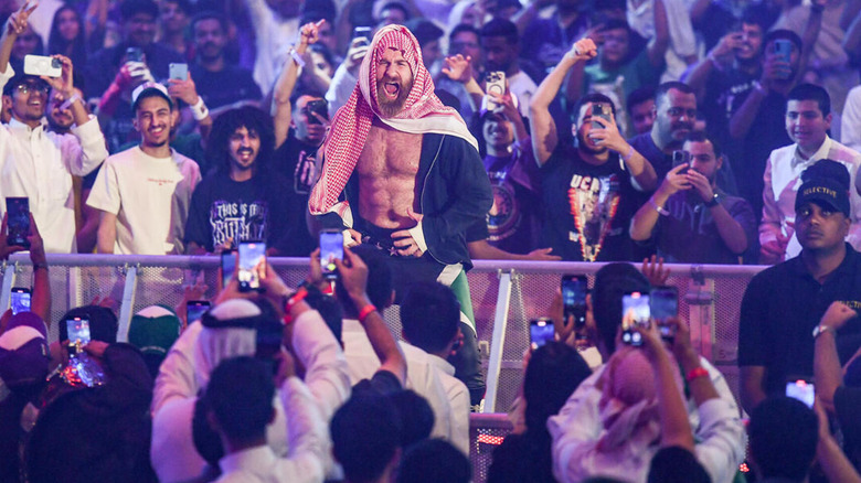 Sami Zayn wears a shemagh as he makes his entrance in Saudi Arabia.