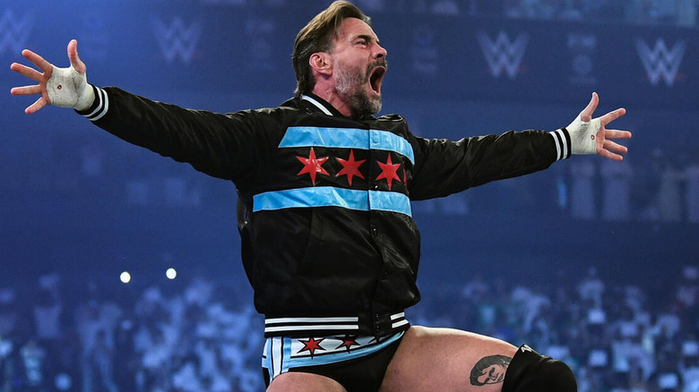 CM Punk poses during his entrance at WWE Night of Champions