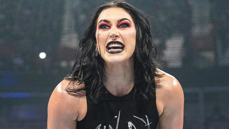 Rhea Ripley bares her teeth in a snarl.