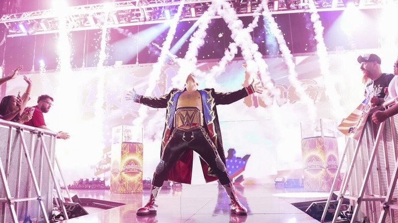 Cody Rhodes poses amidst pyro on the stage on "WWE SmackDown"