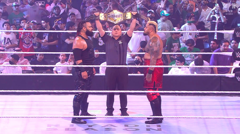 Fatu and Sikoa staring each other down in the ring