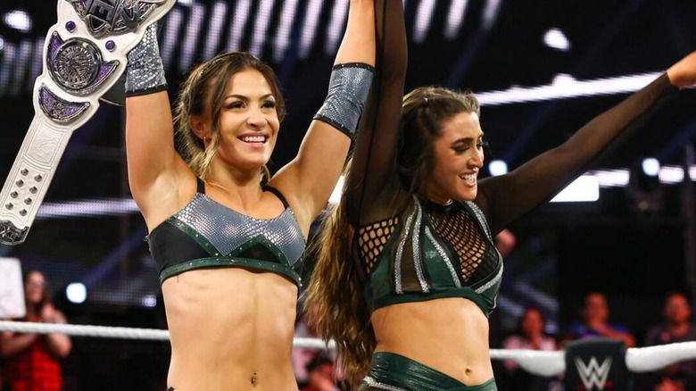 Then-NXT Women's Champion Kendal Grey and Wren Sinclair have their arms raised in victory after a tag team match on "WWE NXT."