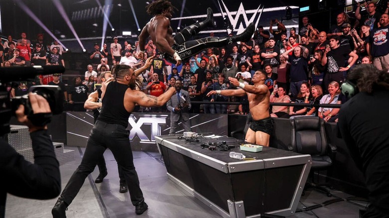 DarkState hit their team finisher, with Dion Lennox sending Saquon Shugars through the commentary desk with a powerbomb.