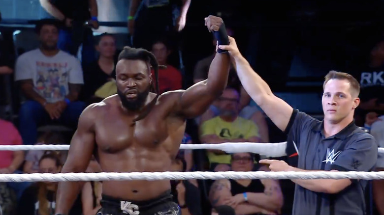 The referee holding up Carver's hand in the ring