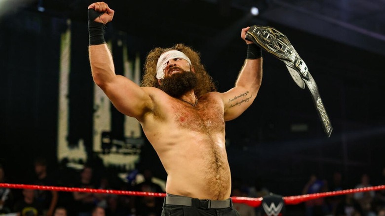 NXT Champion Tony D'Angelo, still wearing gauze over his injured eye, holds up the title in the ring after his victory over Naraku at Great American Bash 2026.
