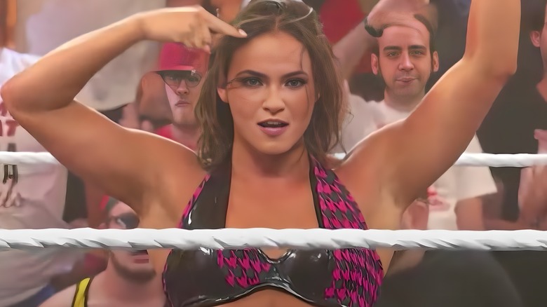 Kiana James pointing at her head