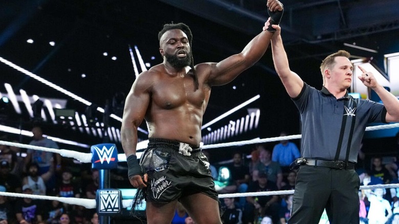 A referee holds up the arm of Keanu Carver after a victory over Hank Ledger on "WWE NXT."