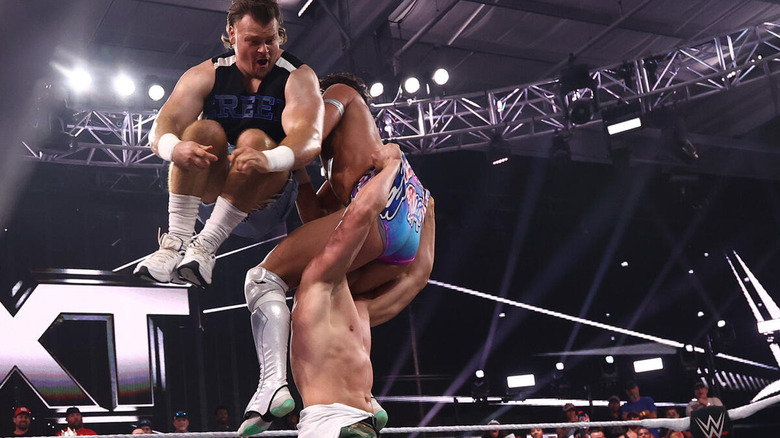 Brutus Creed comes off the top rope on Romeo Moreno while he's in the grasp of Julius Creed on "WWE NXT"