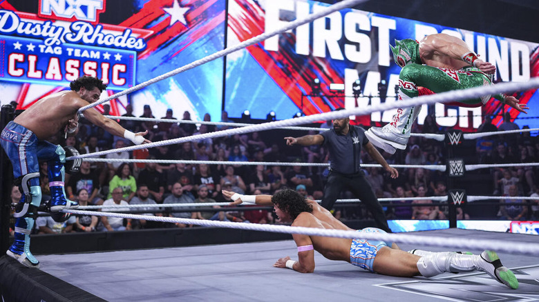 Rayo stomps on Romeo Moreno, as Moreno reaches for a tag with Noam Dar.