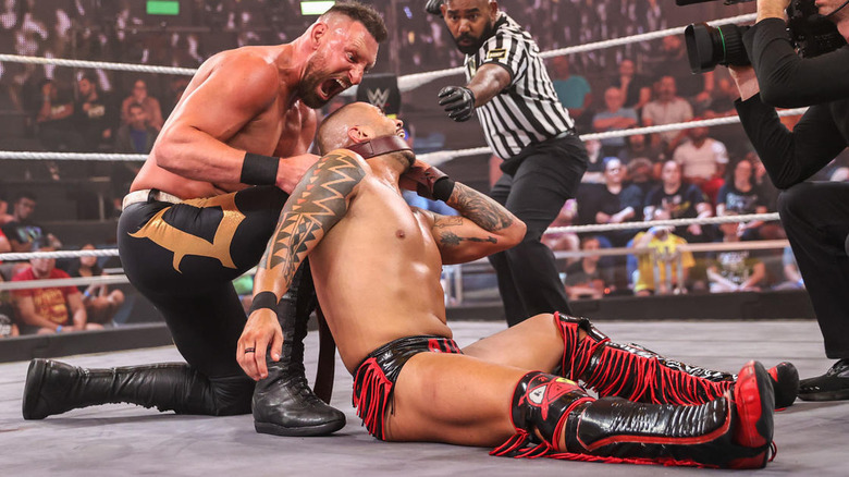 Dijak choking Eddy Thorpe with a strap