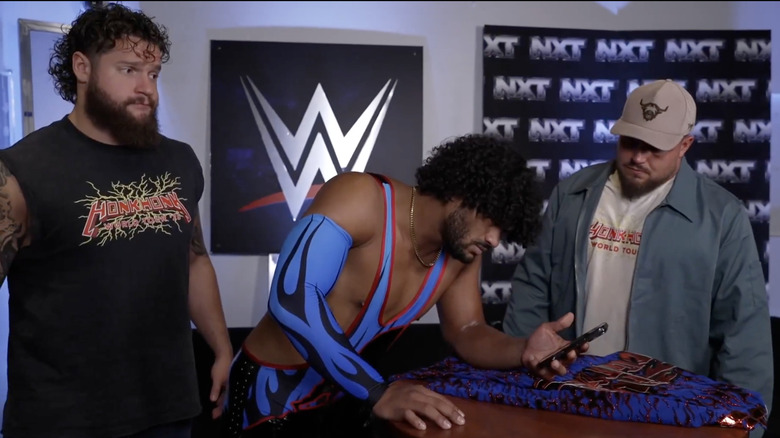 Heights watching a video from Borne as Hank Walker and Tank Ledger stand next to him