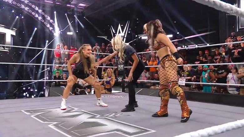 Nattie and Hail staring down one another inside the ring