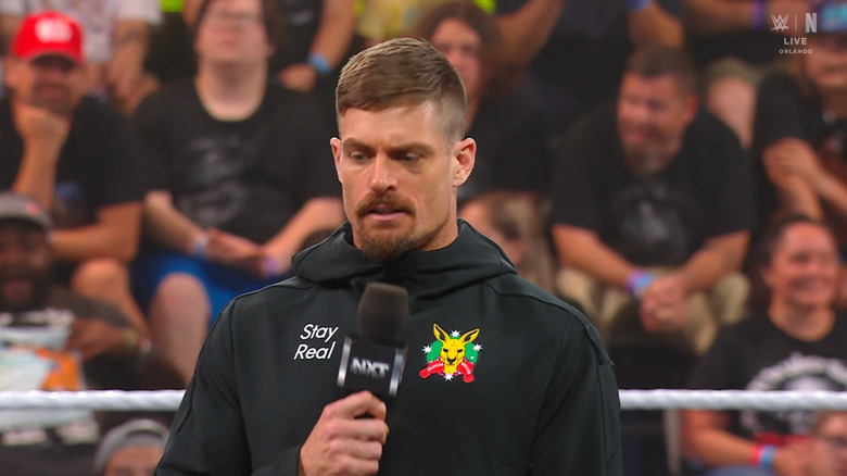 Waller with a microphone in hand inside the ring