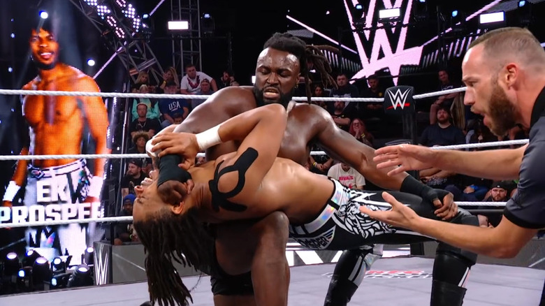 Carver with a backbreaker submission hold cinched in on Prosper