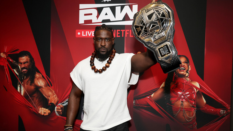 Oba Femi holds up the WWE NXT Title