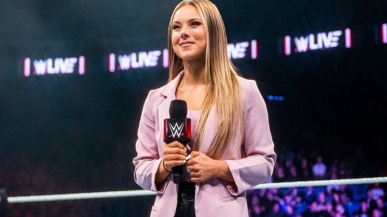 WWE backstage interviewer and reporter Kelly Kincaid prepares for an interview in the ring during a WWE live event.