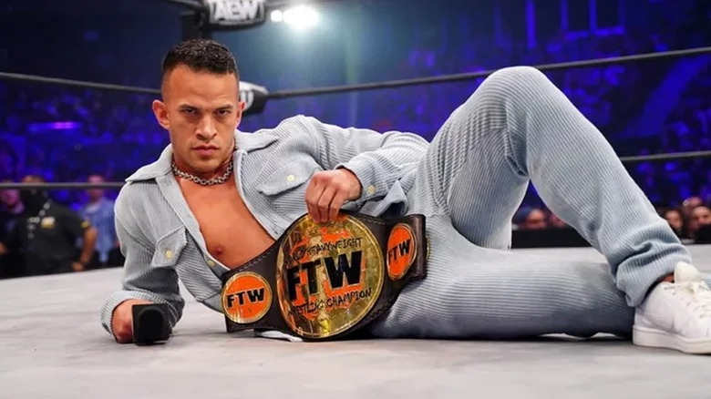 Ricky Starks posing with the FTW Championship while still signed to AEW.
