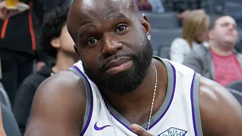 Apollo Crews posing at a basketball game