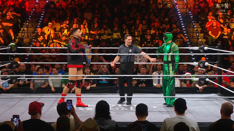 Page and Iguana staring one another down in the ring