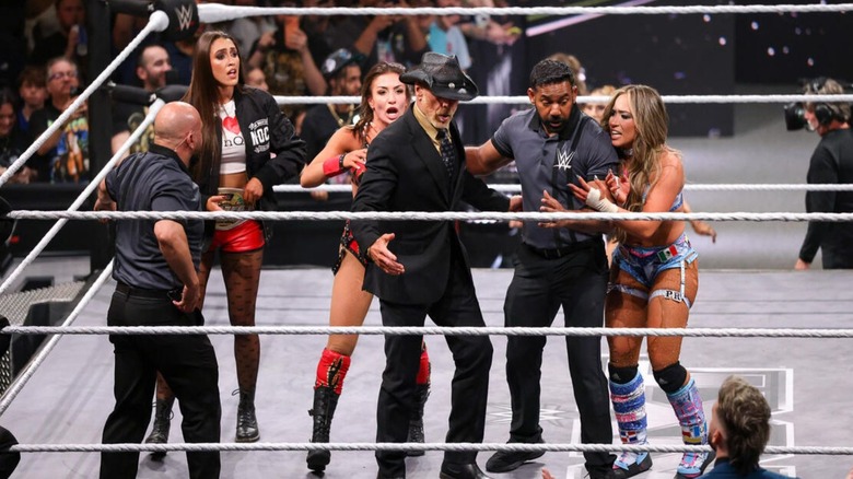 Kendal Grey and Lola Vice plead their cases to Shawn Michaels and referees, as Wren Sinclair looks on stunned, following their chaotic number one contender's match on 