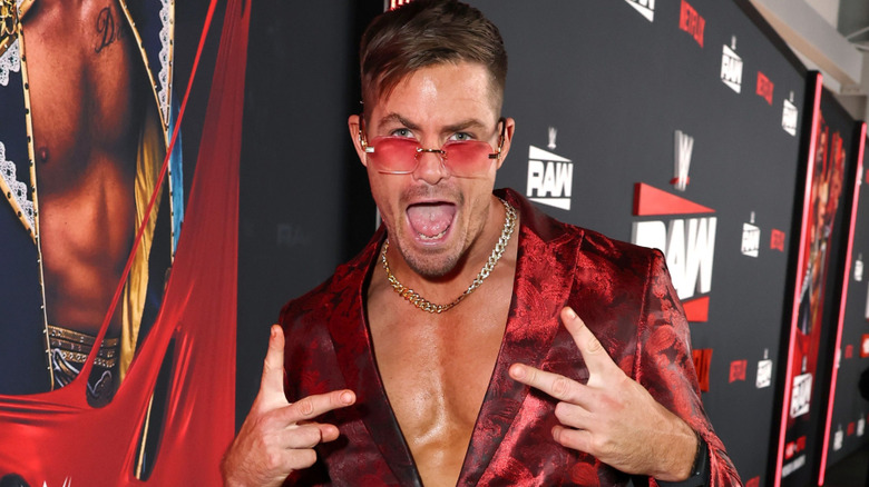 Grayson Waller wearing red sunglasses