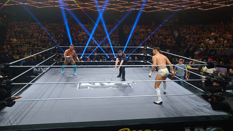 Legacy and Drake staring one another down in the ring