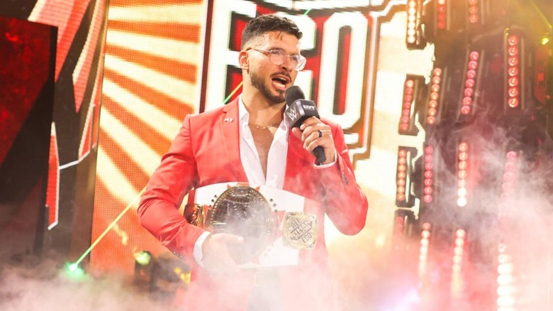 Ethan Page stands on the stage, North American Championship in hand, and addresses El Hijo de Dr. Wagner Jr. in the ring.