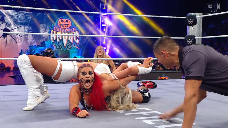 Monroe with an arm submission cinched in on Zaria